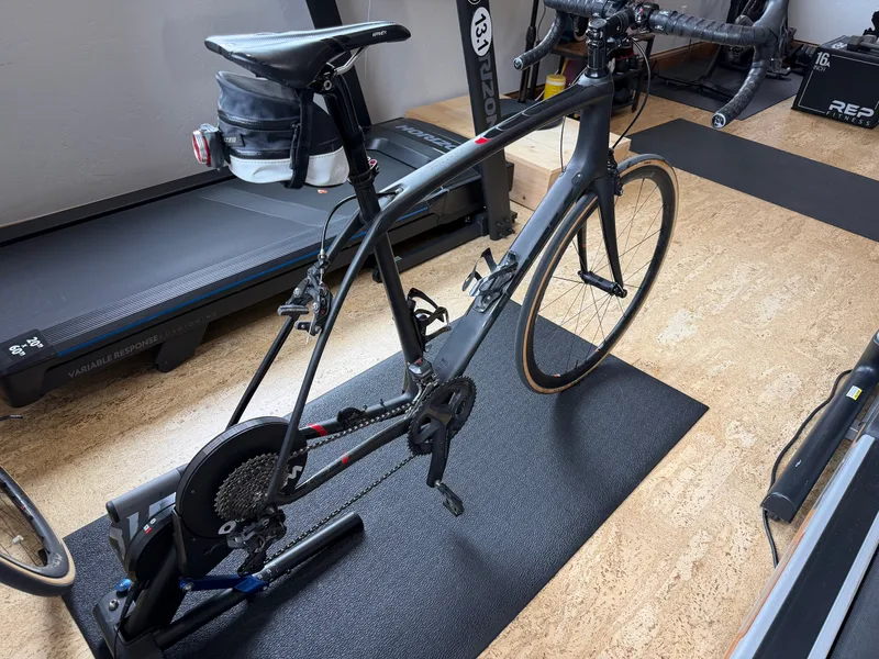 A road bike mounted on an indoor smart trainer